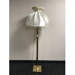 A brass column standard lamp and shade