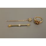 An 18ct gold bar brooch set with an old cut diamond,