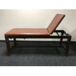 A mid-20th century oak adjustable examination bed