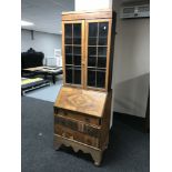 A 20th century walnut bureau bookcase on associated base