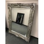A large silvered overmantel mirror in ornate frame,