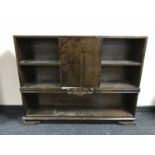 A set of continental walnut open shelves fitted with a cupboard