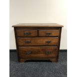 An Edwardian walnut four drawer chest