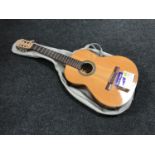 A Spanish acoustic guitar in carry bag and a hands free auto tuner