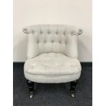 A contemporary button back bedroom chair in beige fabric