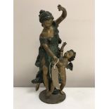 A patinated bronzed sculpture depicting a maiden with winged angel, standing on circular plinth,