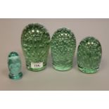 A graduated set of three Victorian glass dumps with bubble inclusions,
