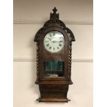 A 19th century mahogany wall clock with mirrored panelled back