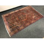 A North West Persian rug on burnt-orange ground,