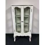 A cream French style double door display cabinet