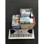 A child's electric keyboard, nine Doc McStuffins jigsaws, assorted board games,