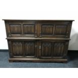 A carved oak linen fold secretaire cocktail sideboard CONDITION REPORT: 110cm high