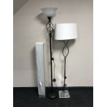 A black uplighter with white glass shade,