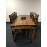 A pine dining table with wrought iron fittings and six chairs