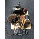 A tray of two pairs of leather cased binoculars,
