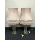 A pair of cut glass table lamps with shades