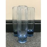 Three Holmegaard Per Lutken blue glass cylindrical vases, height 22 cm.