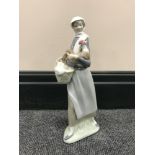 A Lladro figure of a lady carrying a cockerel,
