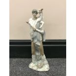 A Lladro figure of a man carrying goat