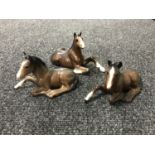 Three brown gloss Beswick lying foals (3)