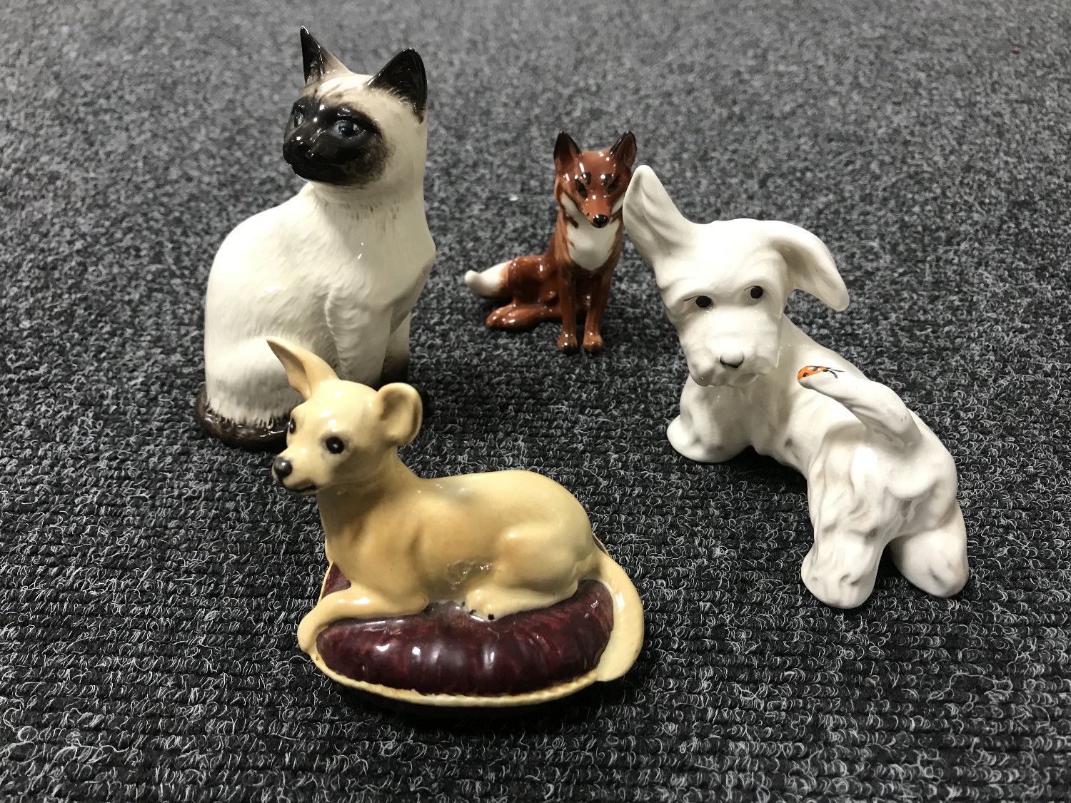 A Beswick figure - Siamese cat, number 1887, a Beswick figure of a fox,