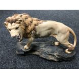 A Beswick figure - a lion on a rock, model 2554A,