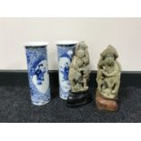 A pair of Oriental soapstone figures on stands together with a pair of twentieth century blue and