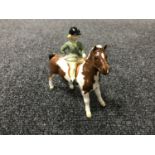 A Beswick figure - a girl on a pony, skew bald, model 1499,