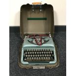A boxed Singer electric sewing machine together with a cased Vintage Imperial typewriter