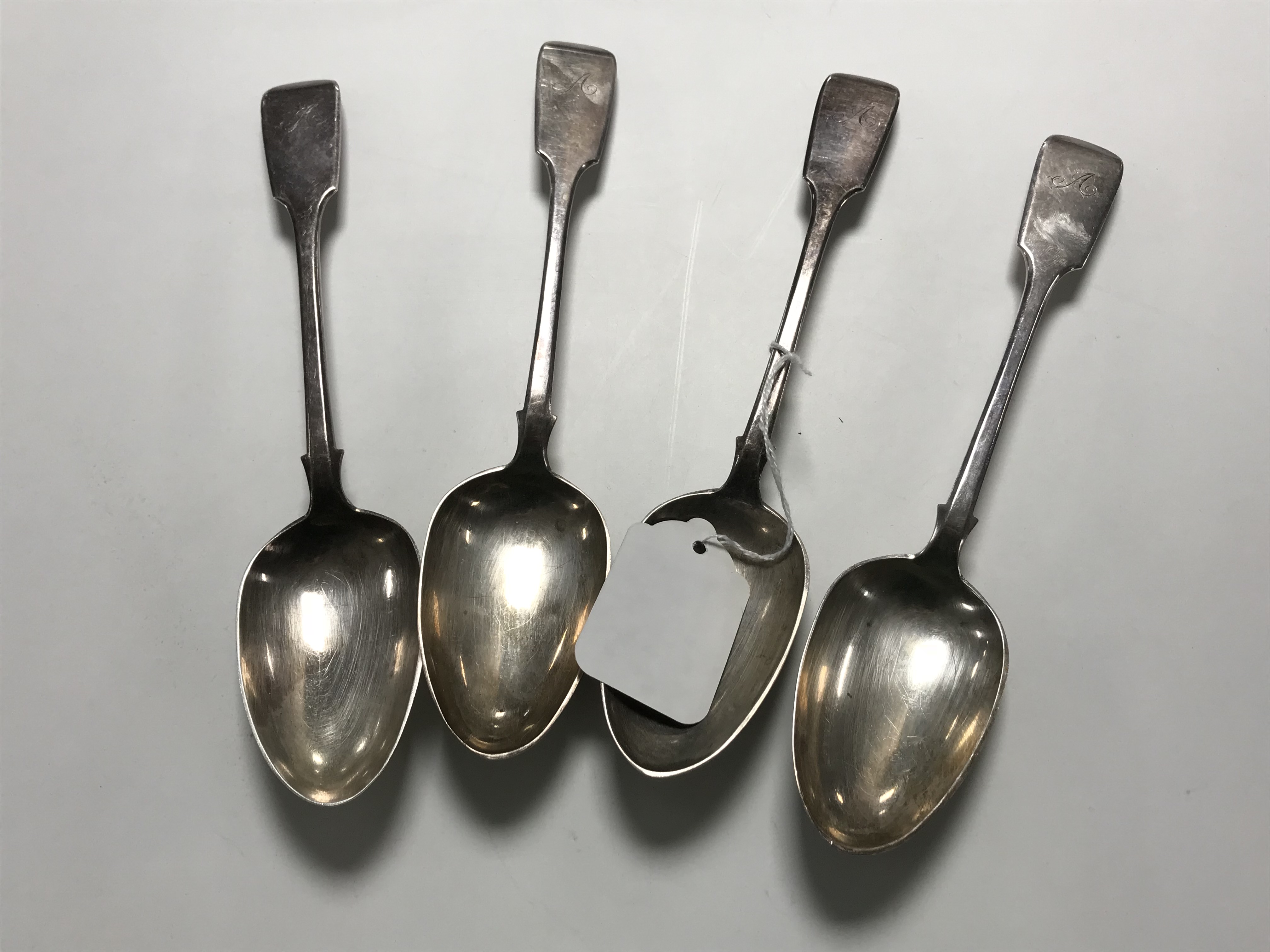 A set of four silver serving spoons