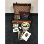 A leather case containing early twentieth century black and white post cards,