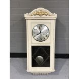 A painted wall clock with silvered dial