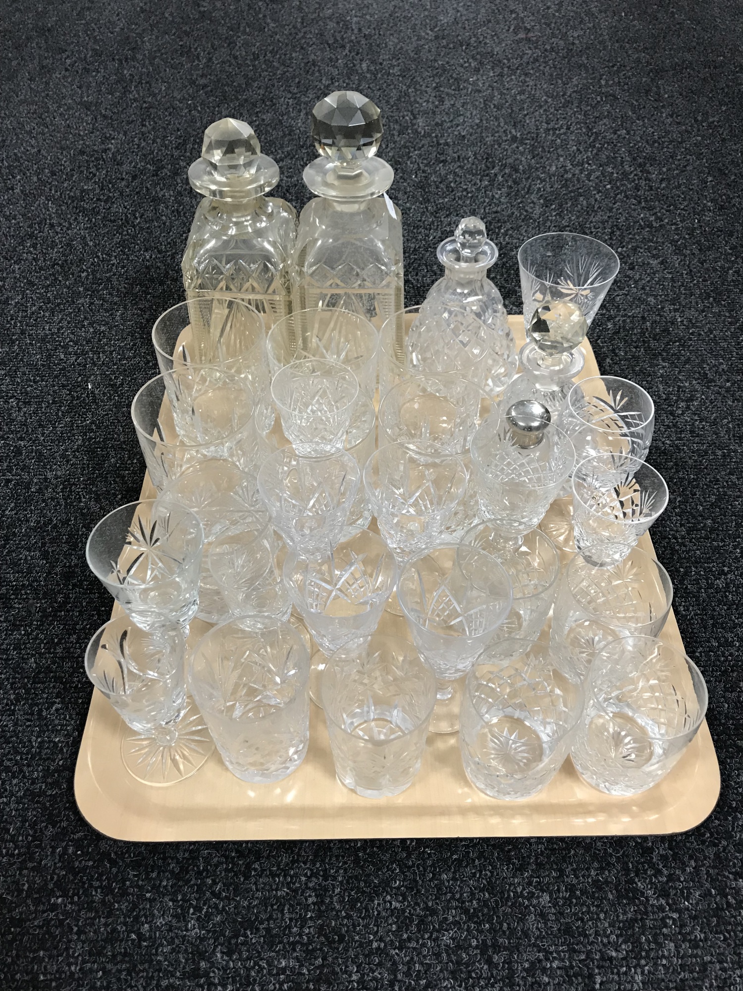 A tray of crystal glasses and decanters