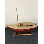 A hand built wooden model of a single mast boat on stand signed Grasole