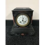 A Victorian slate mantel clock with enamel dial