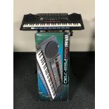 An boxed Yamaha PSS-1190 keyboard on stand