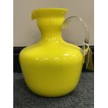 A 1950's Italian Empoli yellow Murano cased glass pitcher with twisted handle, height 24 cm.