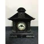 An antique pine cased mantel clock with enamelled dial