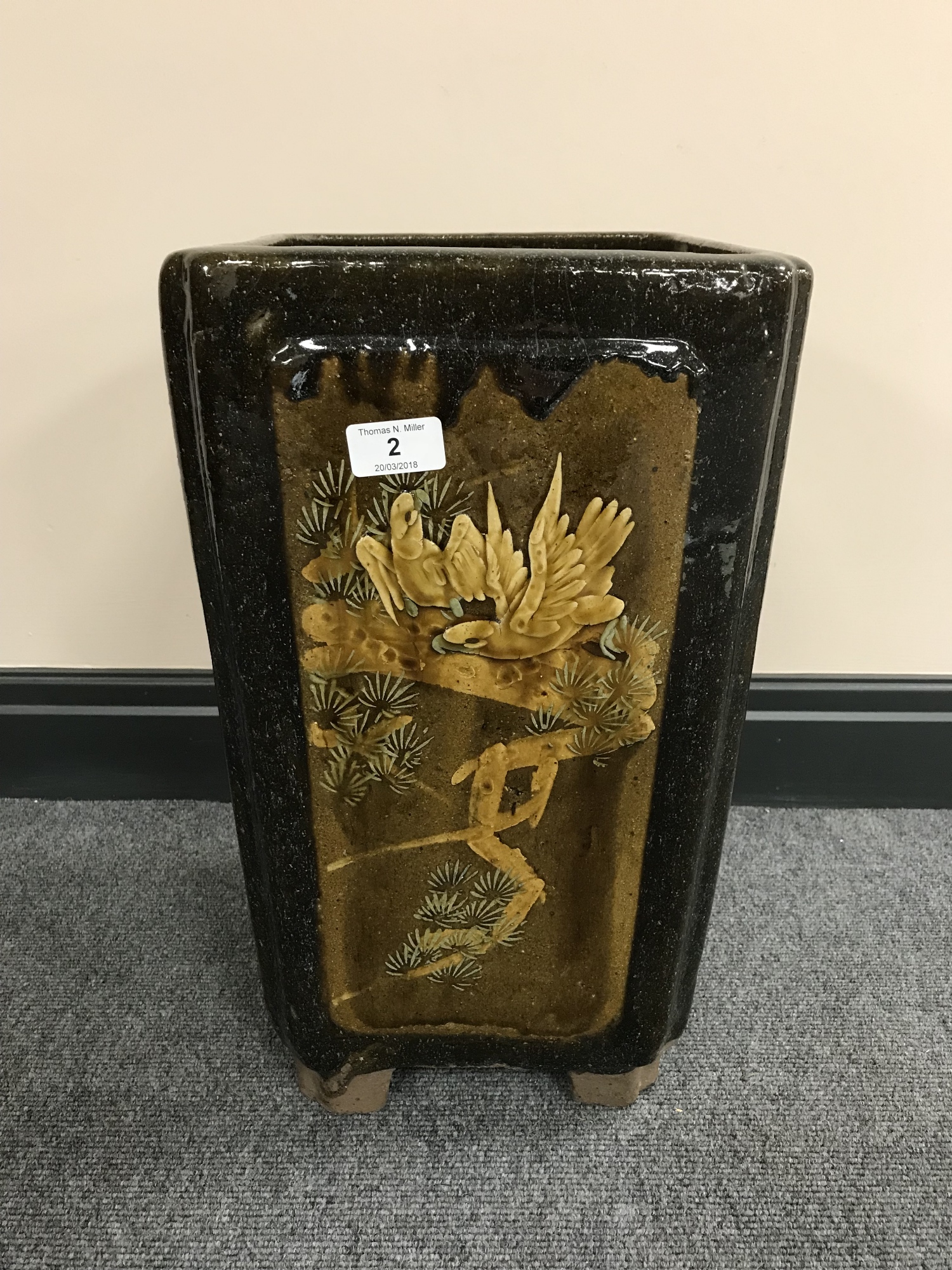 A Chinese earthenware glazed planter with panels depicting bamboo and birds, height 44 cm.