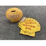 A cast iron shell money box together with a golden shell motor oil advertisement