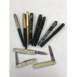 A collection of Parker and other pens, several with gold nibs,