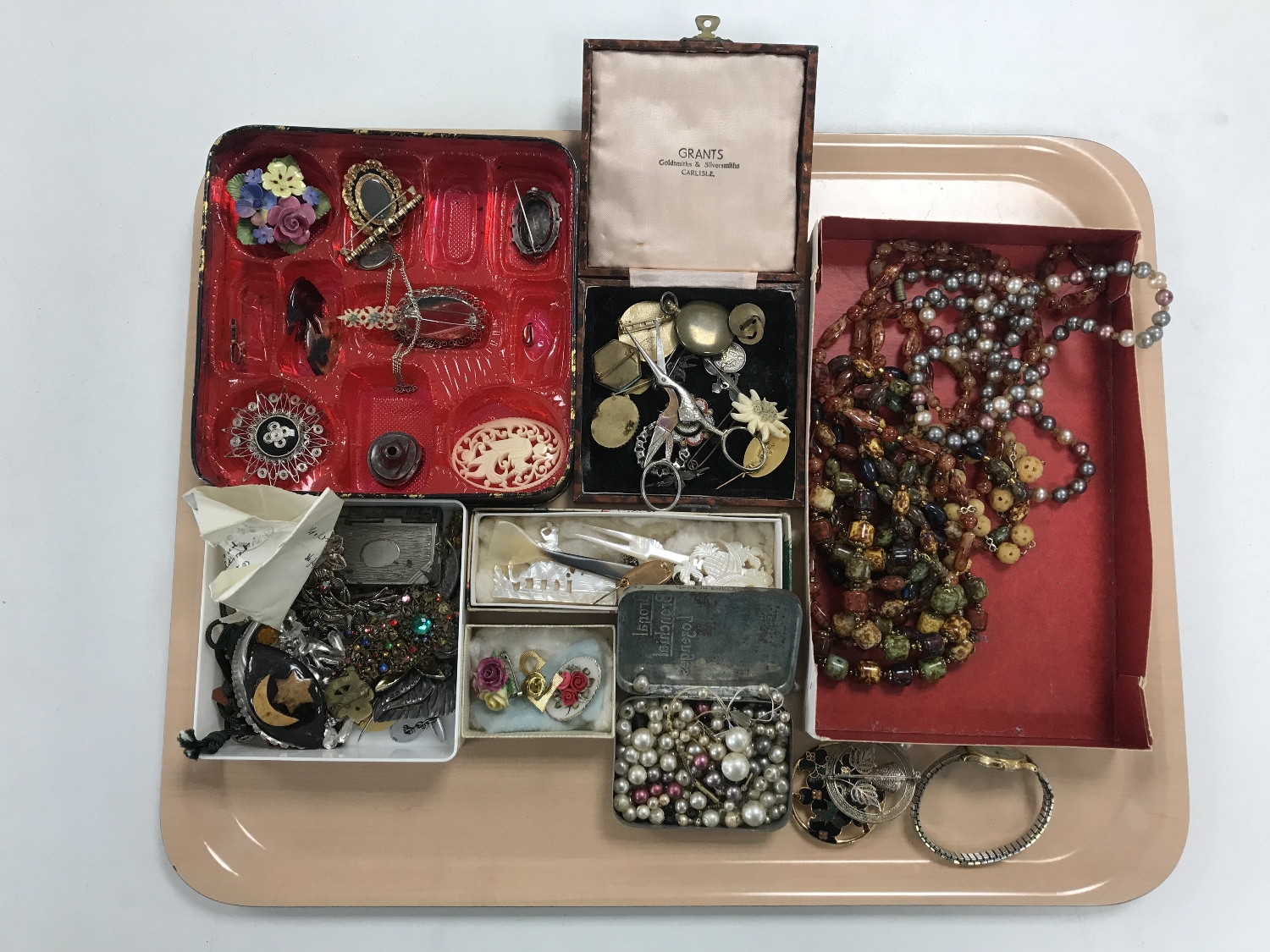 A tray containing a large quantity of costume jewellery including necklaces, brooches, buttons etc.