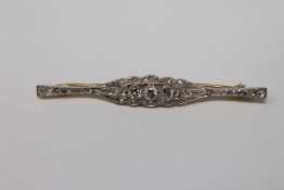 An 18ct gold diamond set bar brooch