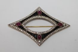 A diamond and jet brooch set with four cabochon rubies