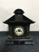 An antique pine cased mantel clock with enamelled dial