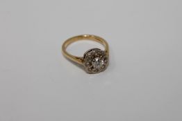 An 18ct gold diamond cluster ring, the central stone estimated at 0.