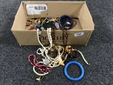 A box containing a quantity of costume jewellery, trinkets, etc.