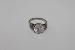 An 18ct white gold dress ring with diamond set shoulders,