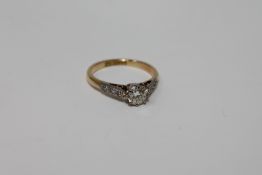 An 18ct gold solitaire diamond ring, approximately 0.5ct, size J, set with diamond shoulders.