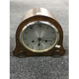 An oak cased mantel clock with silvered dial (with pendulum and key)